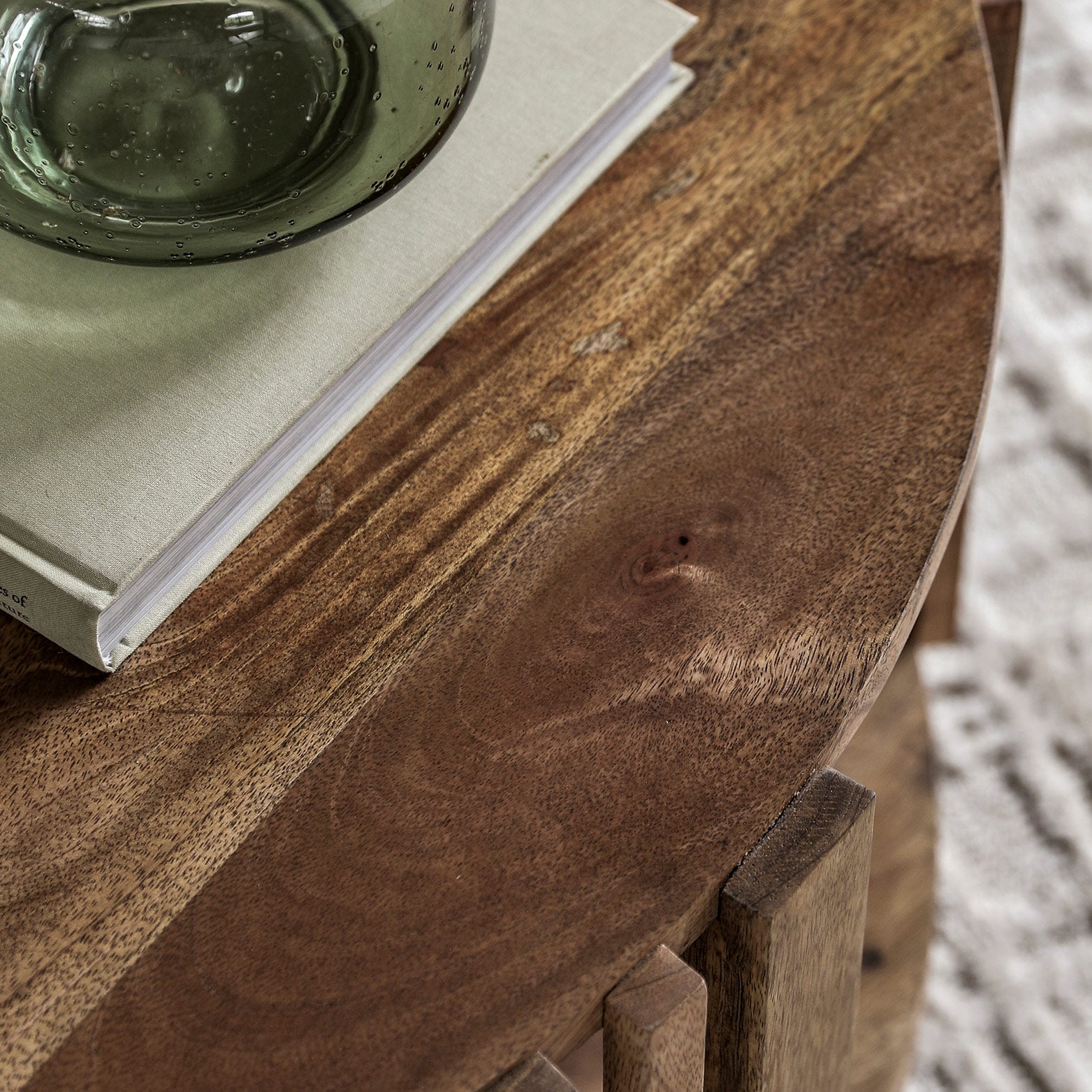 Slatted wooden coffee table in natural finish with lower storage shelf