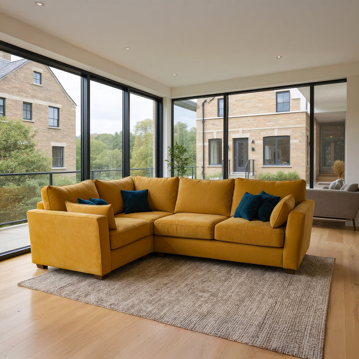 Yellow sectional sofa in a modern living room with large windows.