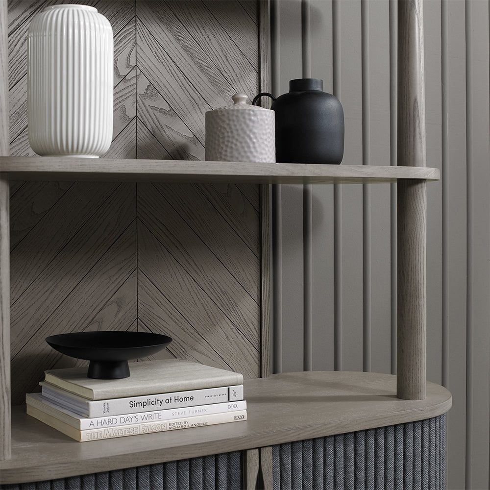 Wooden open display unit with saw-cut ash chevron pattern in silver grey finish and black powder coated metal base

