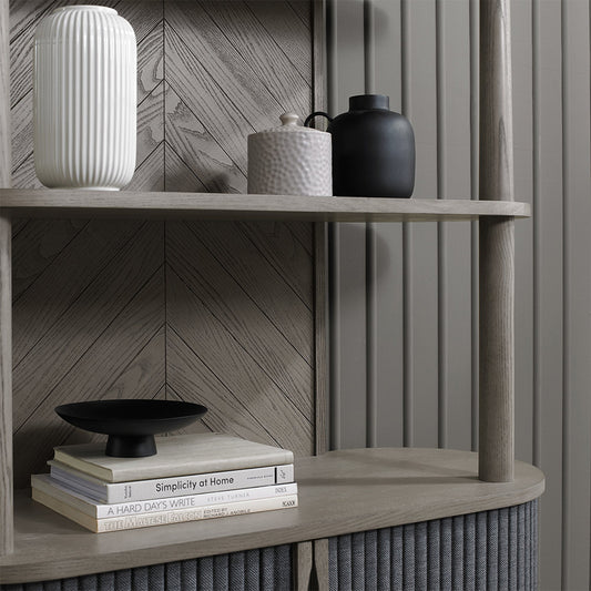 Wooden open display unit with saw-cut ash chevron pattern in silver grey finish and black powder coated metal base
