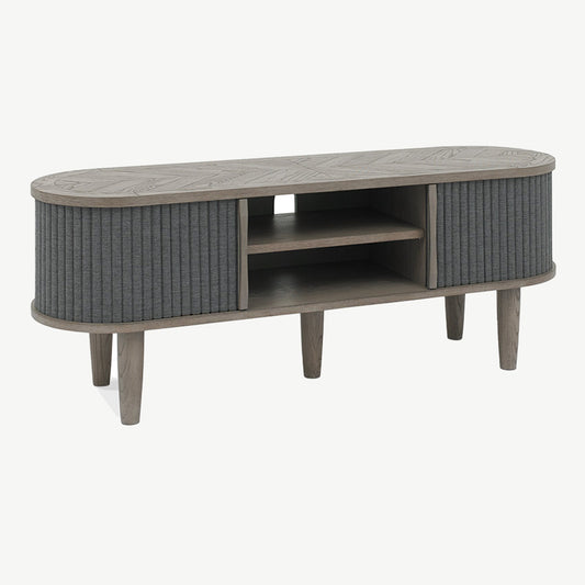 Wooden entertainment unit with saw-cut ash chevron pattern in silver grey finish and black powder coated metal base
