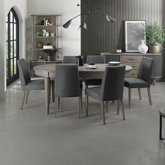 Oval shaped extending wooden dining table with saw-cut ash chevron pattern in silver grey finish
