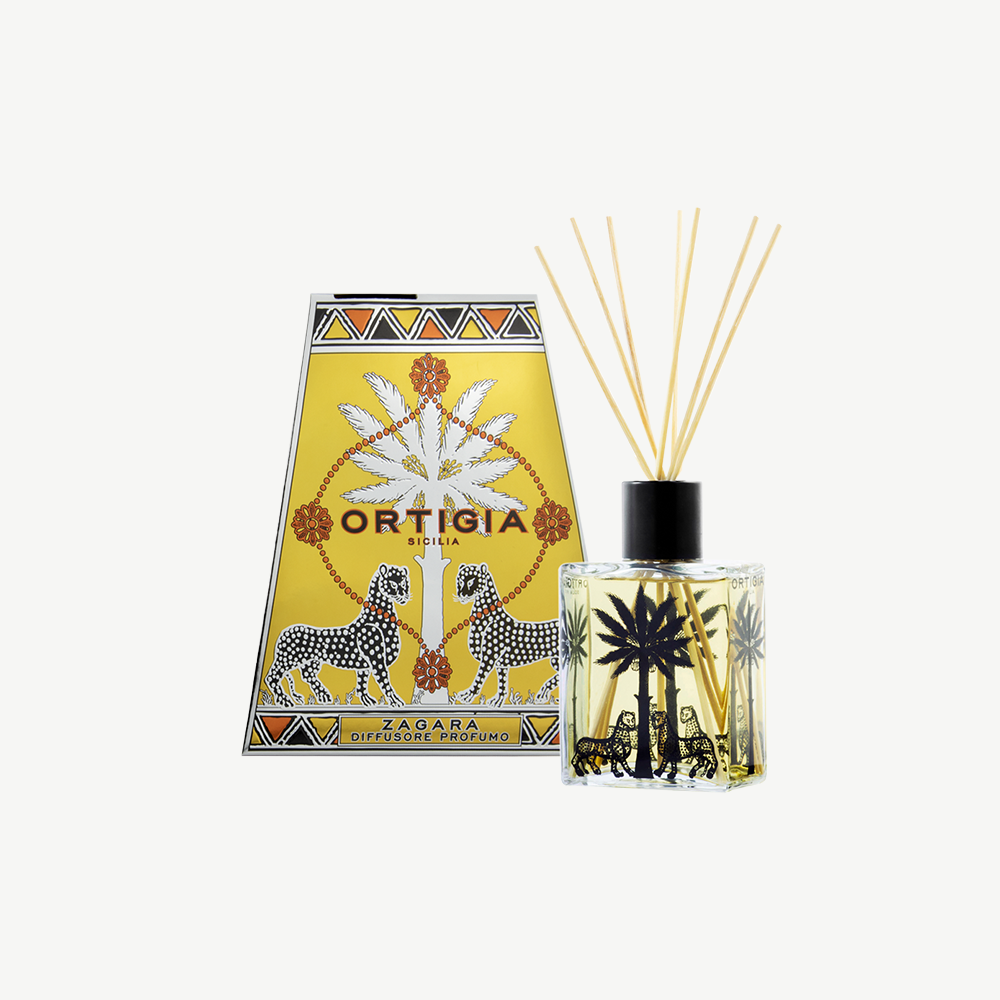 Ortigia Zagara diffuser in signature clear glass printed bottle and accompanying natural diffuser reeds