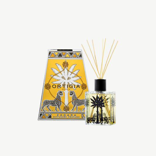 Ortigia Zagara diffuser in signature clear glass printed bottle and accompanying natural diffuser reeds
