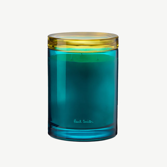 Paul Smith Sunseeker Scented Candle housed in tinted turqoise glass vessel and contrasting collar that doubles as a coaster