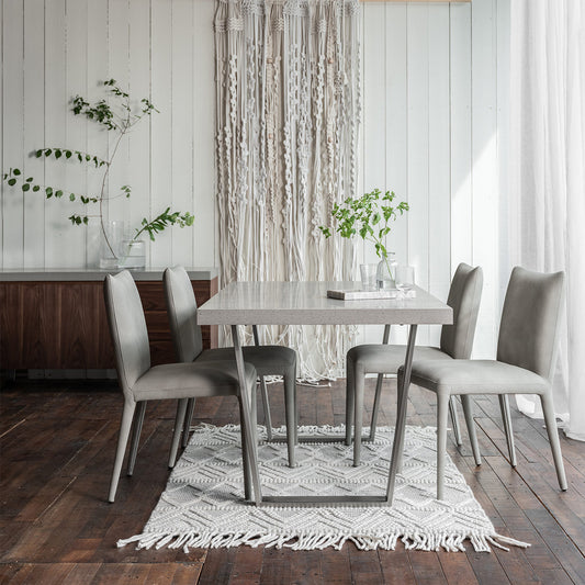 Solid stone effect grey toned rectangular dining table set upon modern angular legs
