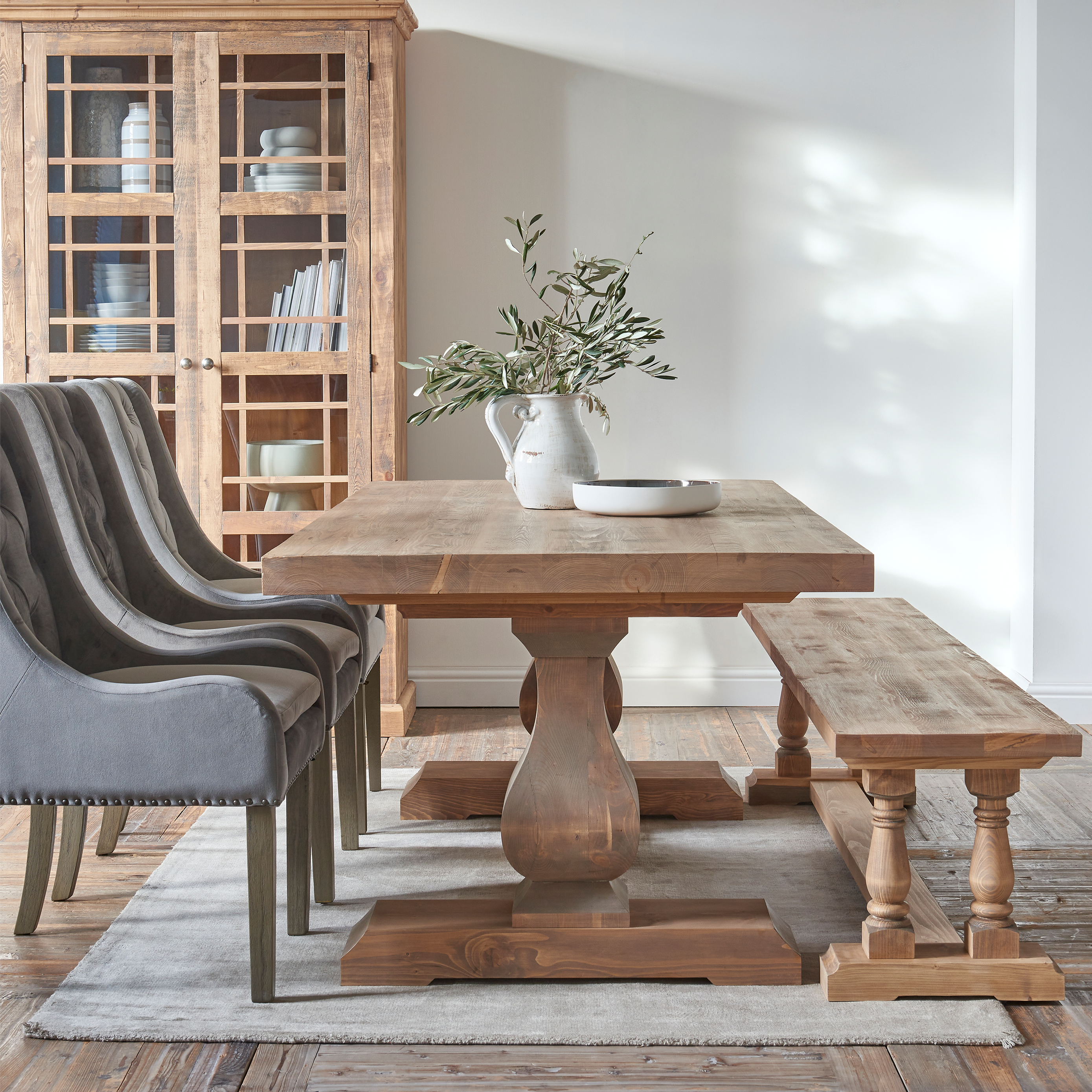 Reclaimed timber dining table in natural finish with solid legs and base