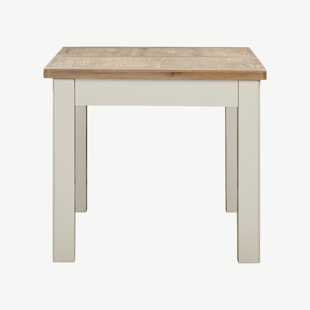 Extending rectangular dining table with natural wood top and painted off-white legs

