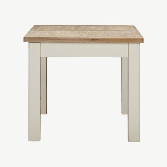 Extending rectangular dining table with natural wood top and painted off-white legs
