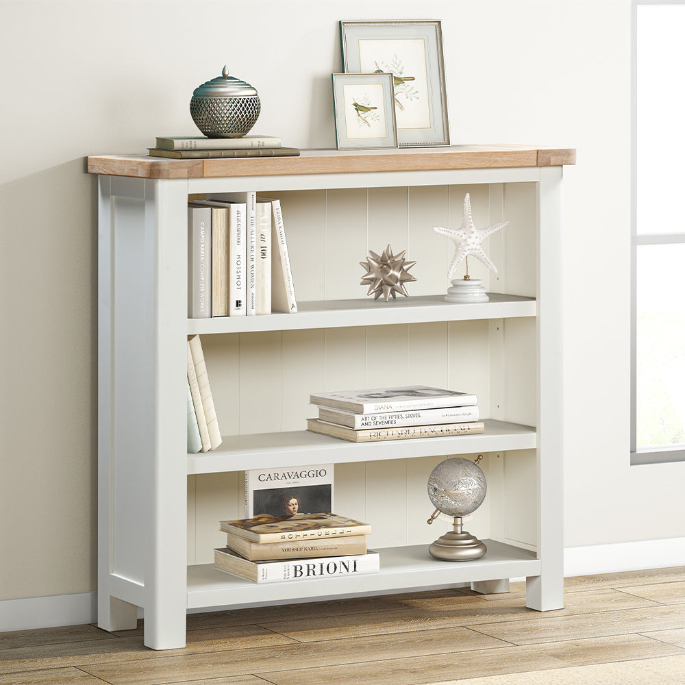 Painted off-white bookcase with natural wood top and three spacious shelves
