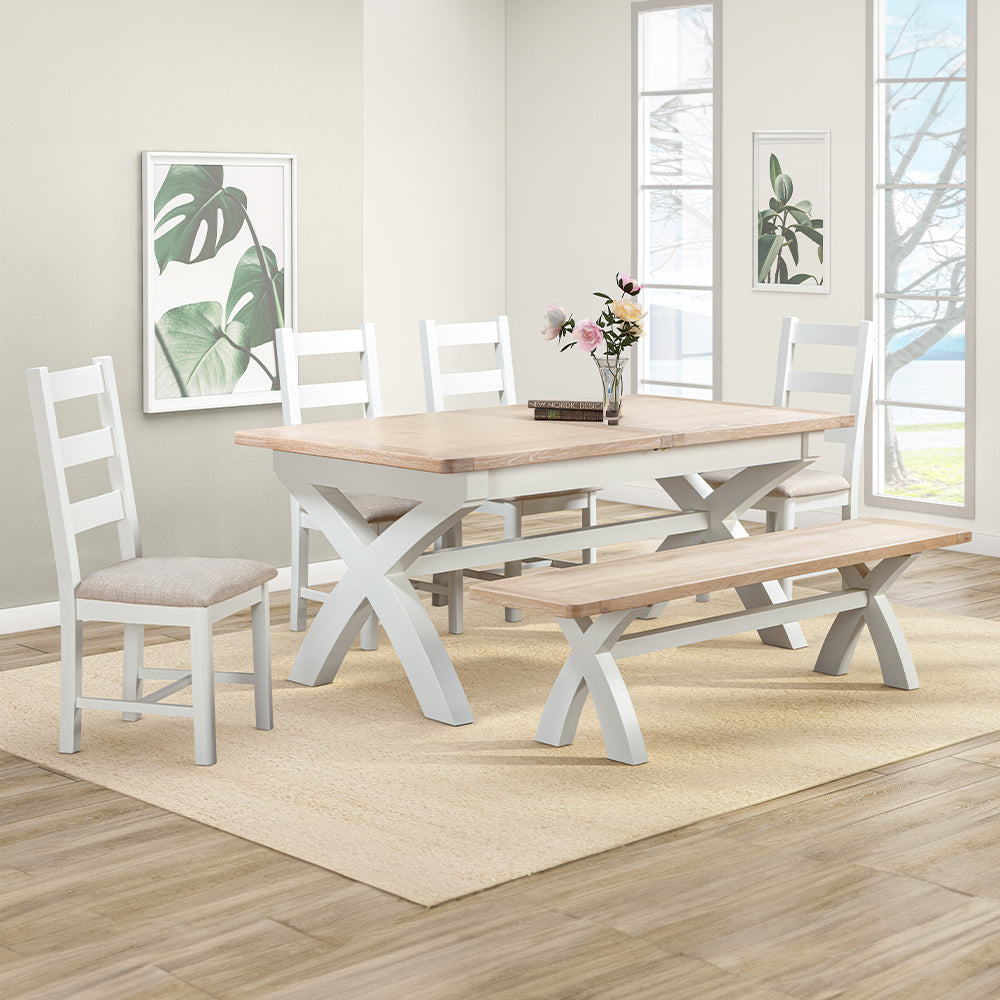 Extending rectangular dining table with natural wood top and painted off-white cross legs
