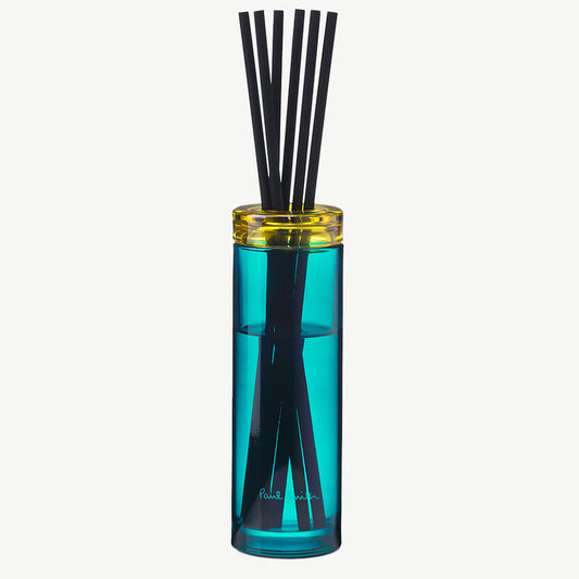 Paul Smith Sunseeker Diffuser housed in tinted turquoise glass vessel and contrasting collar with black diffuser reeds