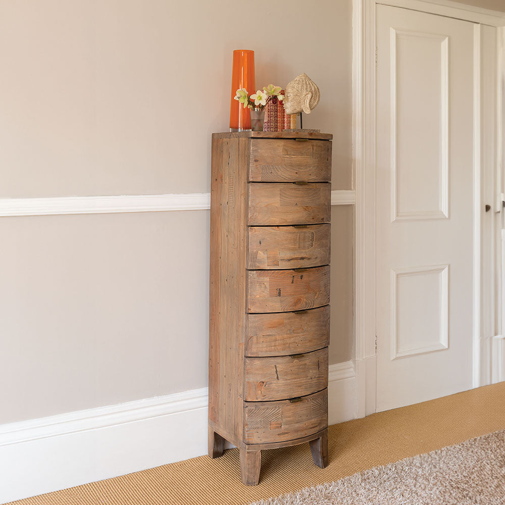 Reclaimed timber wood 7 drawer tall chest in sundried finish with seven curved drawers
