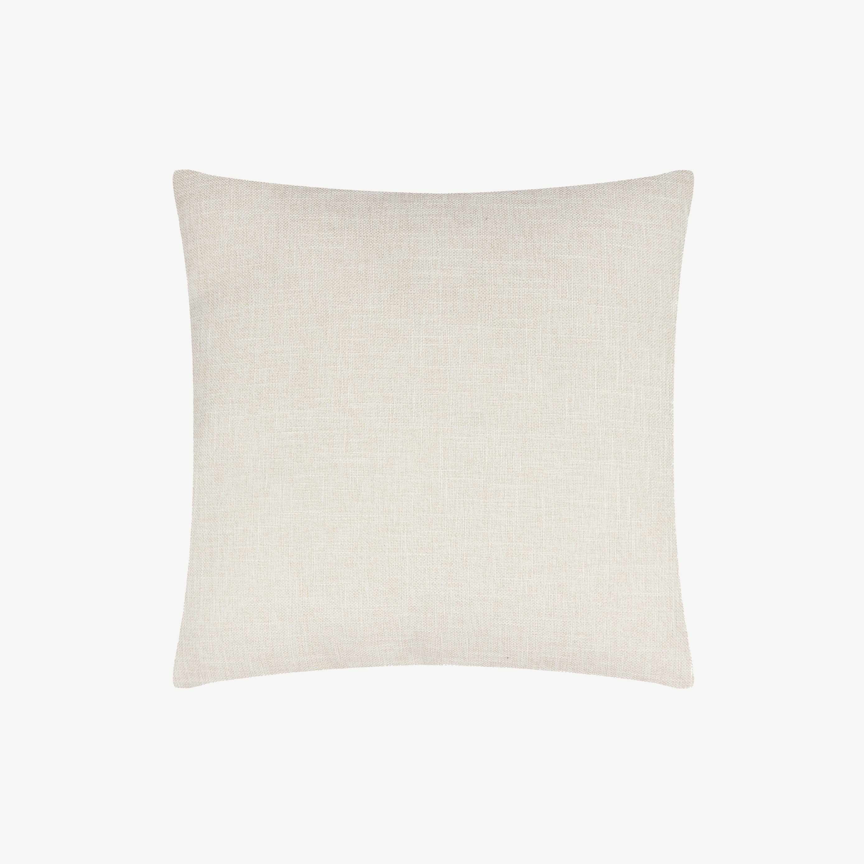 Square fabric scatter cushion with jungle design against soft pink background with neutral off white reverse side