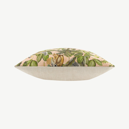 Square fabric scatter cushion with jungle design against soft pink background with neutral off white reverse side