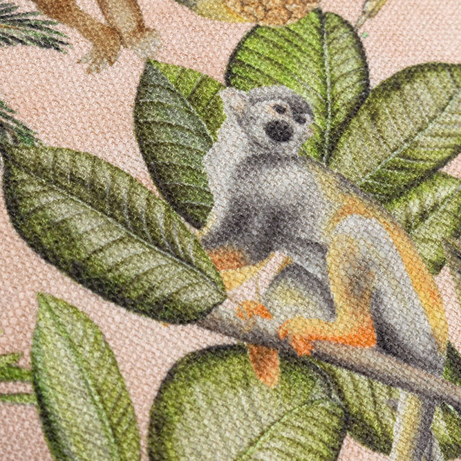 Square fabric scatter cushion with jungle design against soft pink background with neutral off white reverse side
