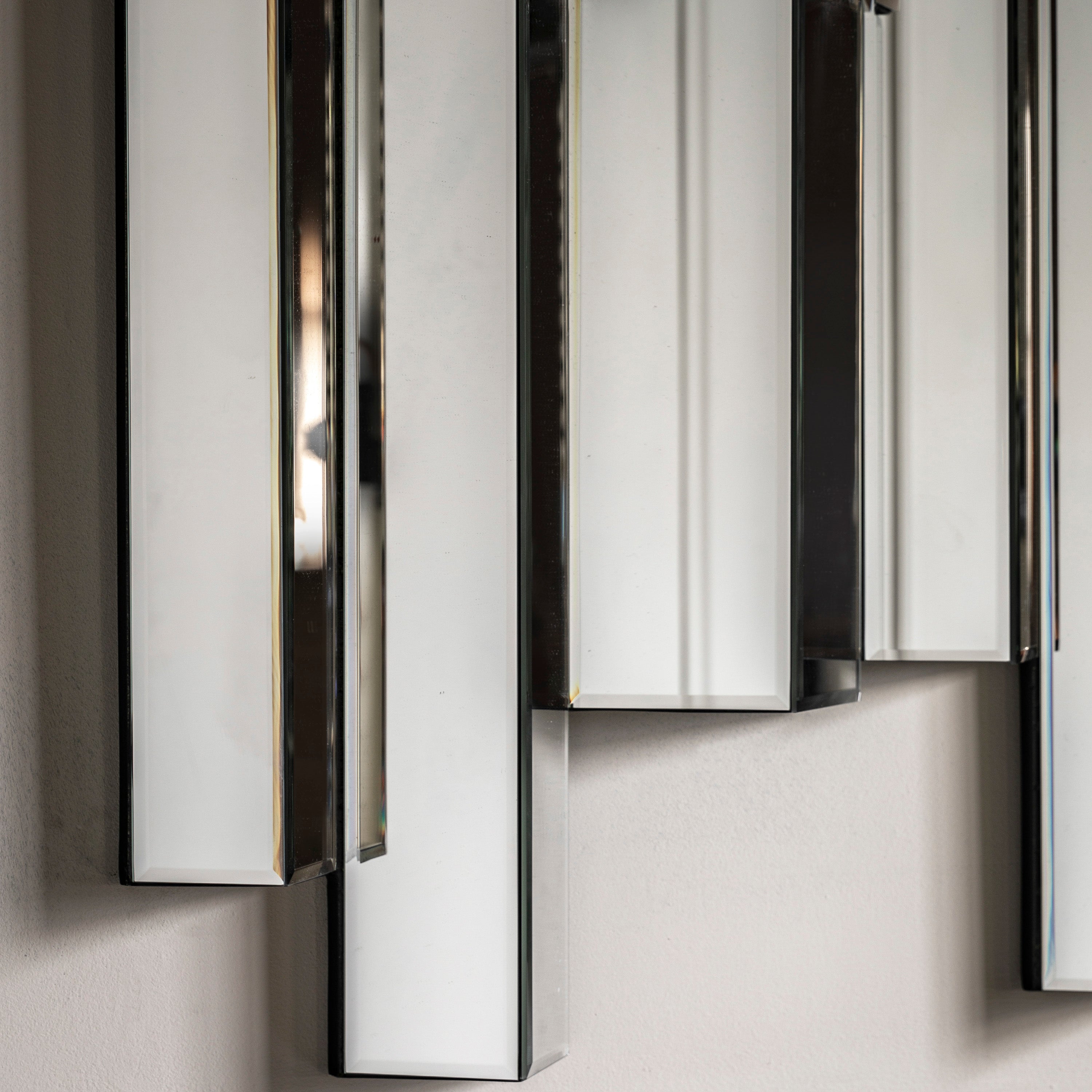 Modern wall mirror with abstract bevelled panelling