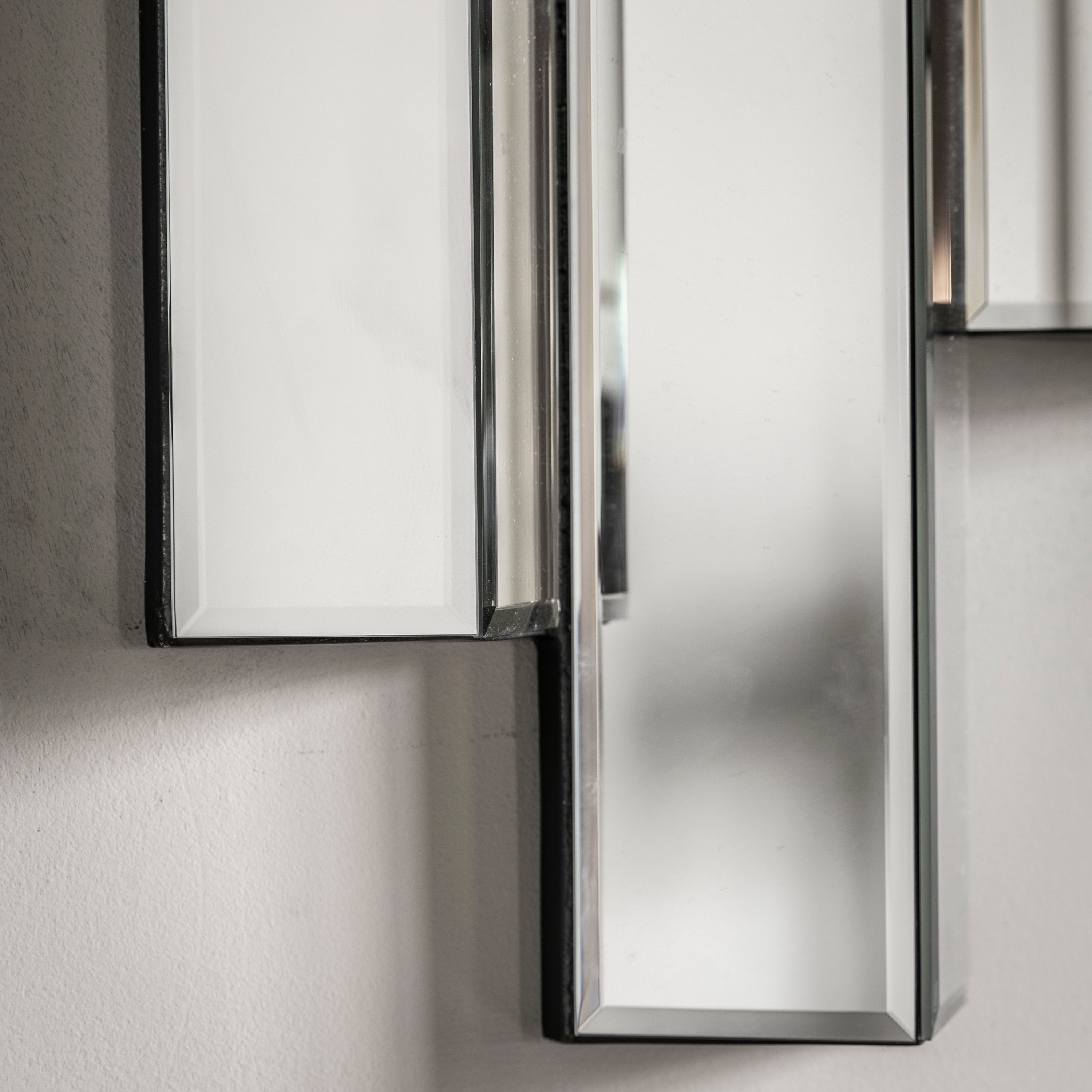 Modern wall mirror with abstract bevelled panelling