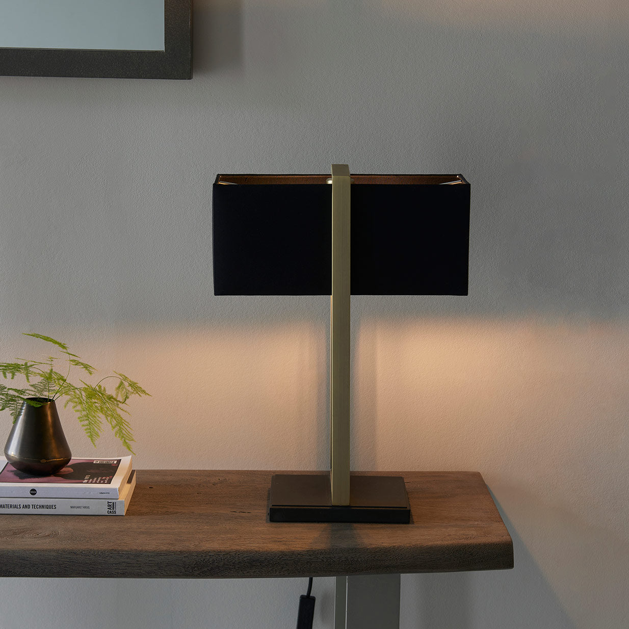 Modern table lamp with matt black base, antique brass finished frame and black cotton shade