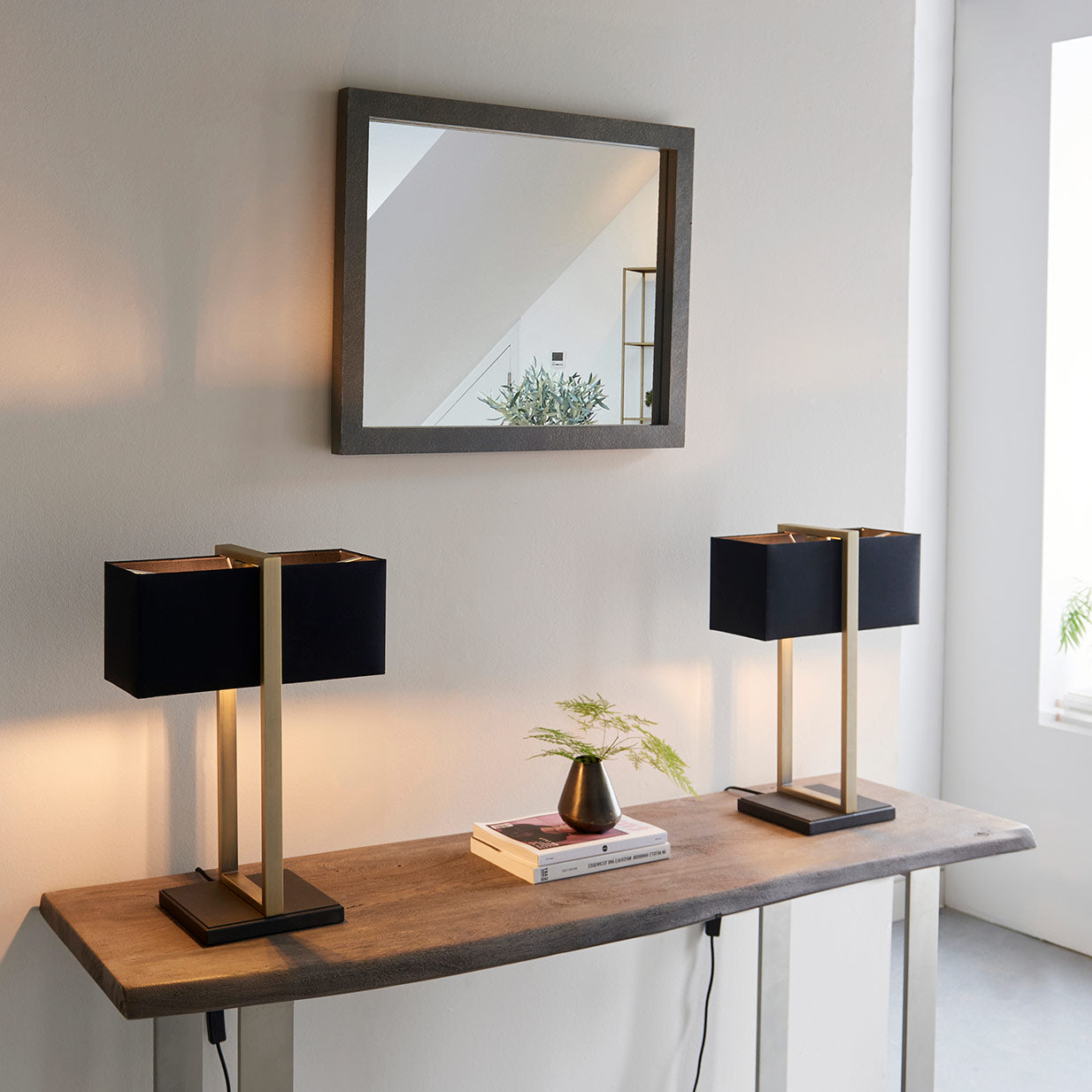 Modern table lamp with matt black base, antique brass finished frame and black cotton shade