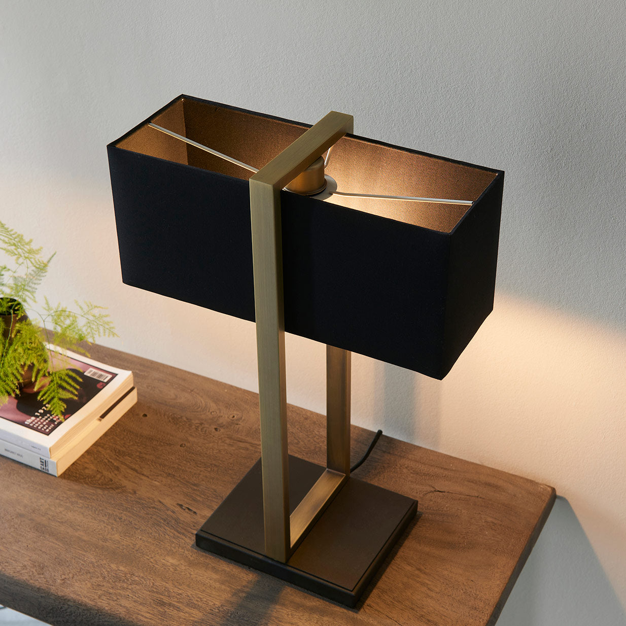 Modern table lamp with matt black base, antique brass finished frame and black cotton shade