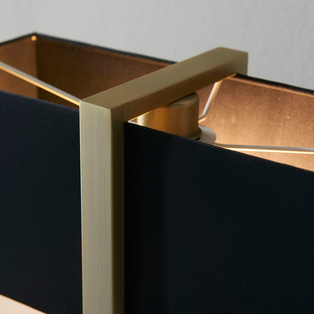 Modern table lamp with matt black base, antique brass finished frame and black cotton shade