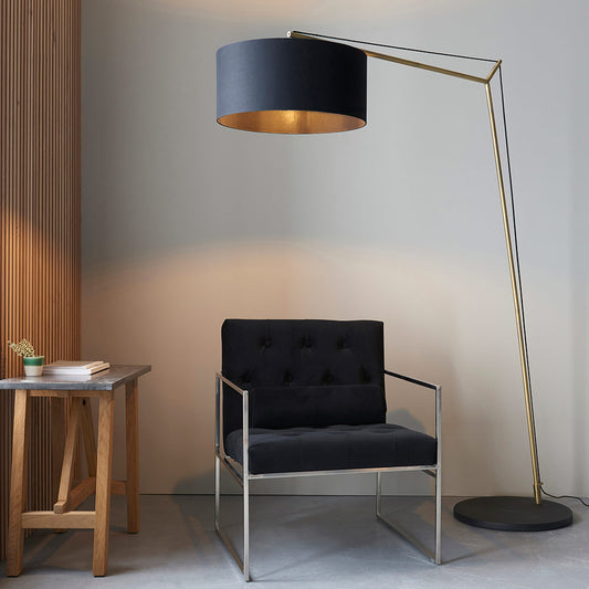 Angular floor light with matt brass plated stem, black painted base and black cotton fabric shade
