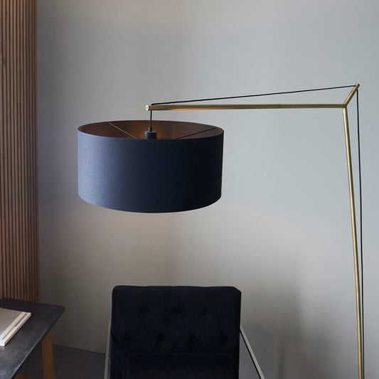 Angular floor light with matt brass plated stem, black painted base and black cotton fabric shade