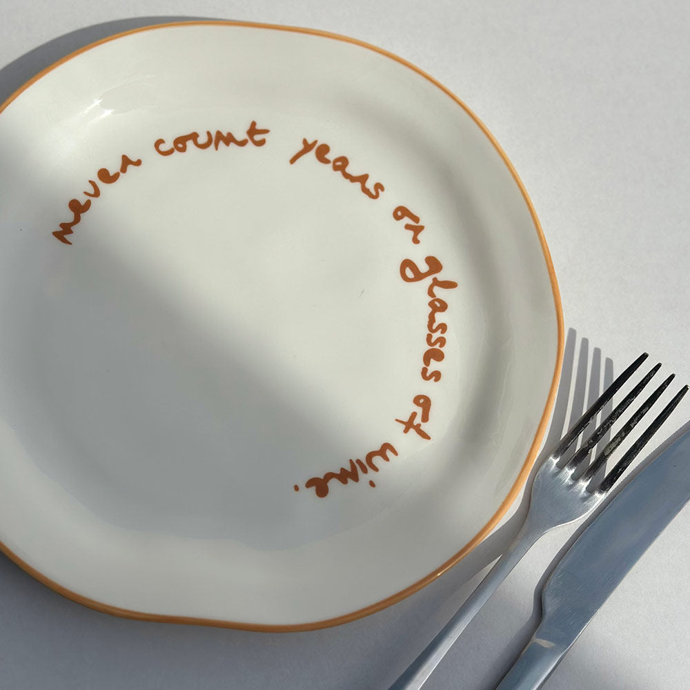 "Never count years or glasses of wine" Orange Decorative Plate