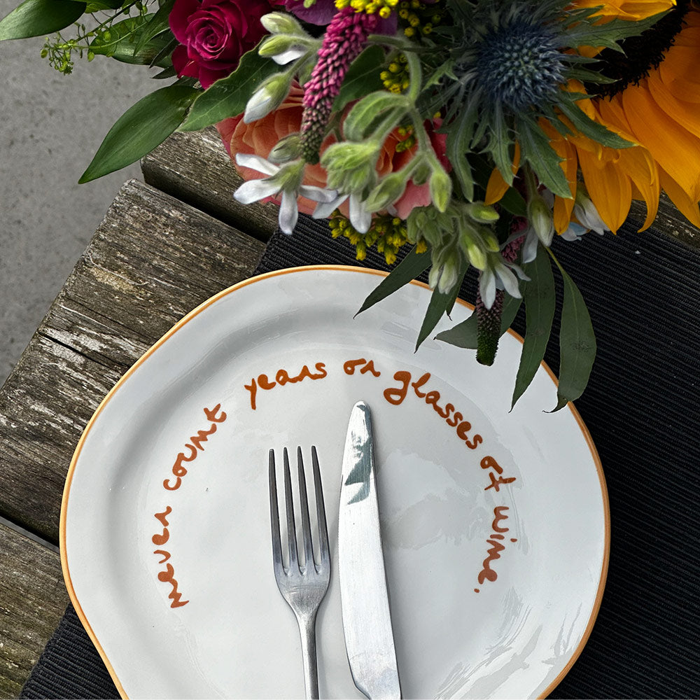 "Never count years or glasses of wine" Orange Decorative Plate