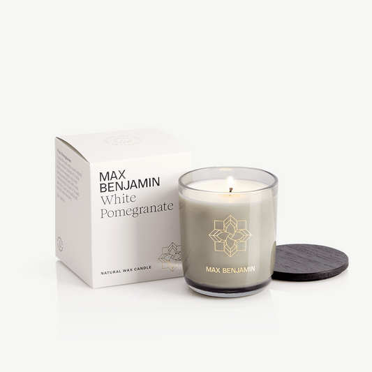 White pomegranate candle in smoked glass candleholder