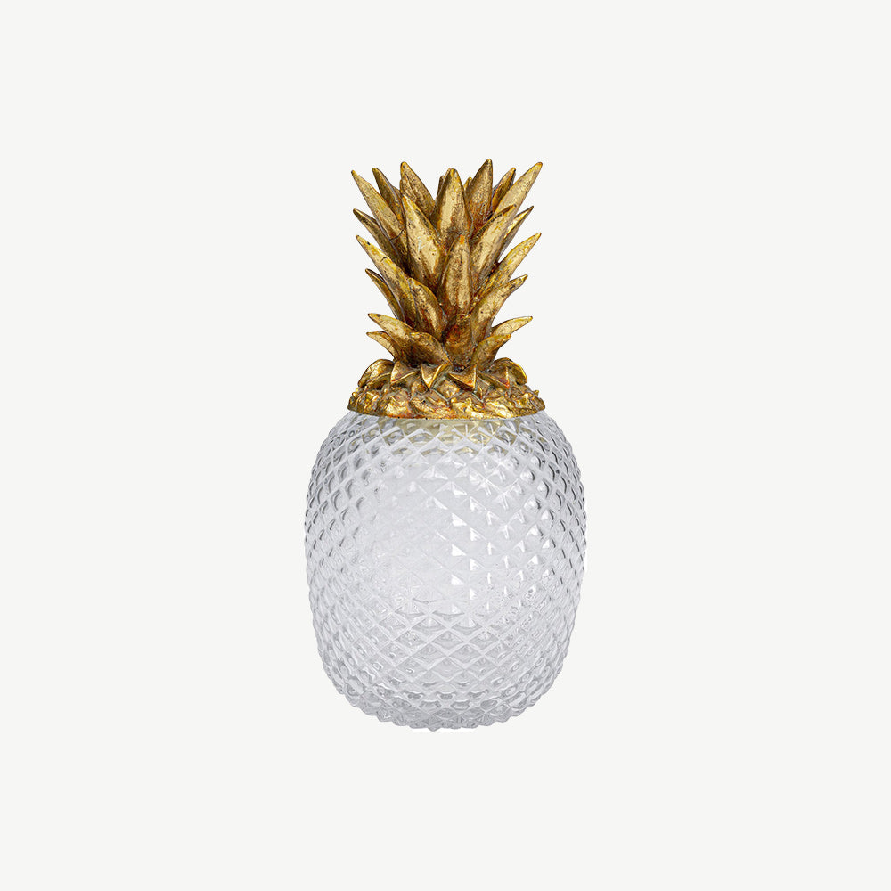 Decorative container in the shape of a pineapple with a gold-coloured lid and transparent body