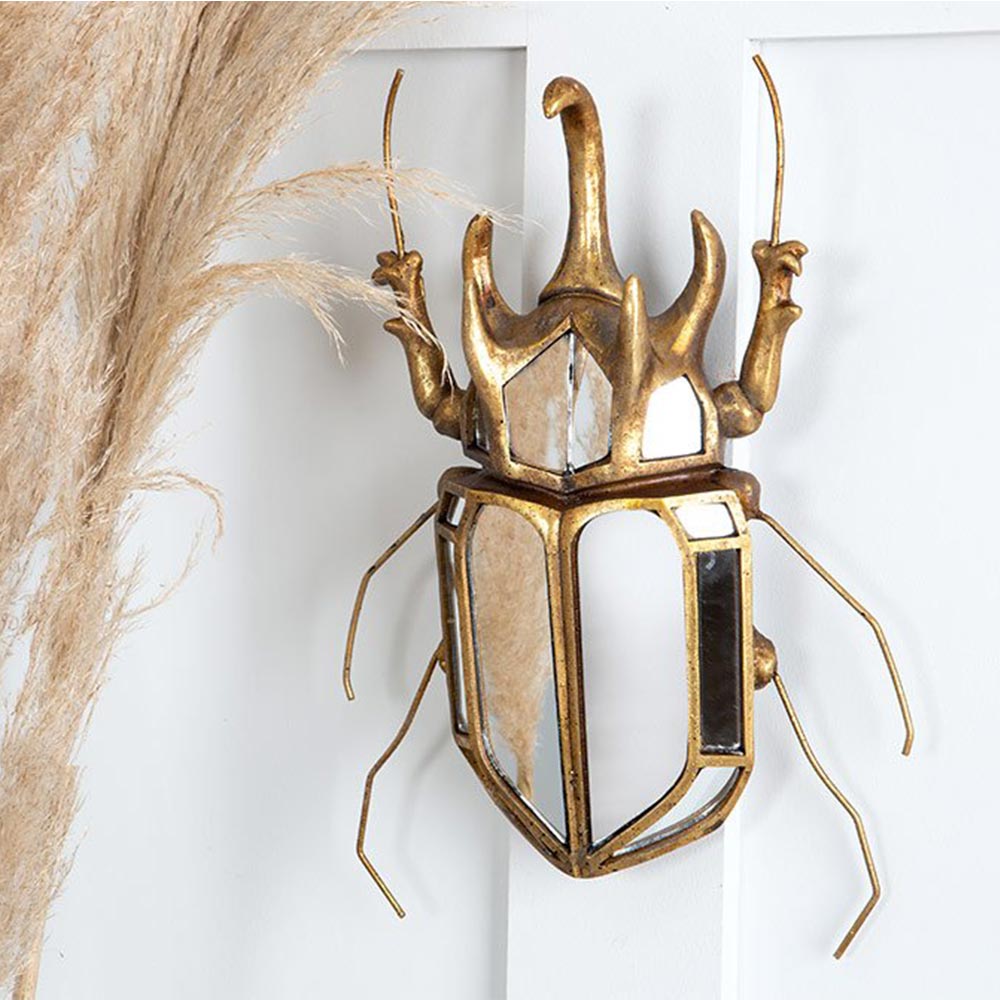 Sculptural beetle shaped wall mirror in gold aged metal finish
