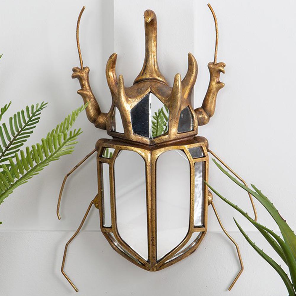 Sculptural beetle shaped wall mirror in gold aged metal finish

