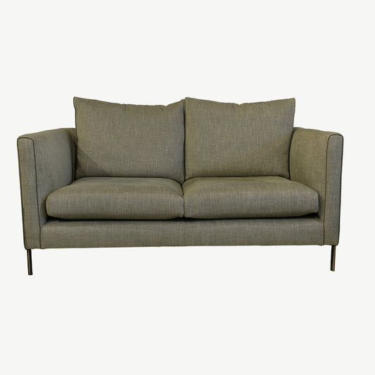 Dark grey sofa in upholstered fabric with leather micro piping on arm fronts