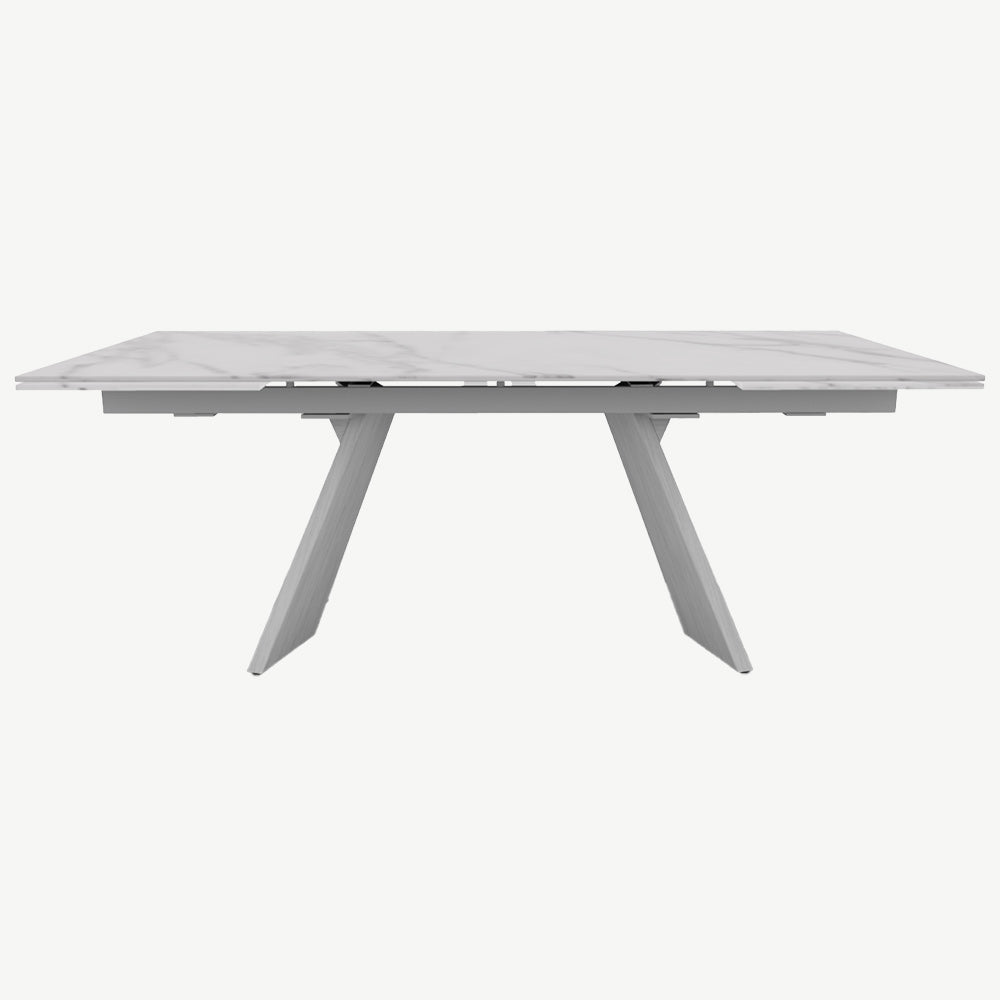 White marble top extending dining table with matt white frame and brushed white legs
