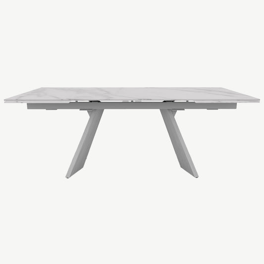 White marble top extending dining table with matt white frame and brushed white legs

