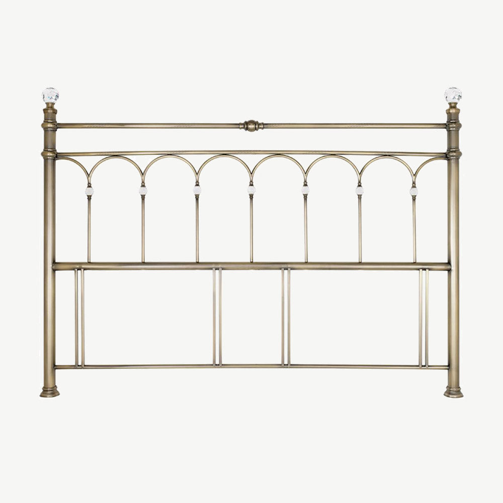 Antique brass headboard with crystal finial detailing