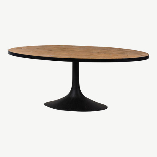 Reclaimed pine oval dining table with natural lacquer finish and black iron detailing