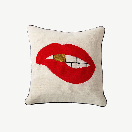 Cream fabric needlepoint pillow embroidered with bold red lip