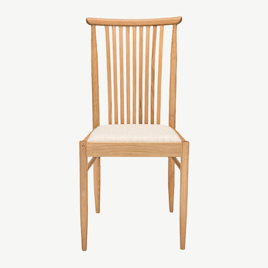 Ercol Teramo dining chair in pale oak finish with slatted back and upholstered fabric seat
