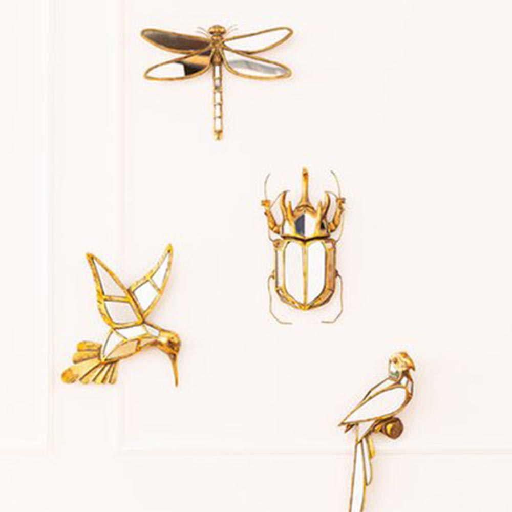 Sculptural beetle shaped wall mirror in gold aged metal finish
