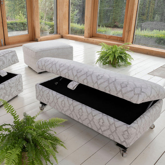 Upholstered footstool in light grey pattern fabric